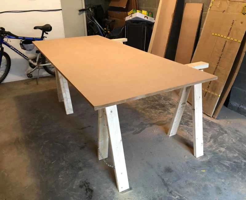 車庫裡,兩根鋸木架上放著一塊中密度纖維板。